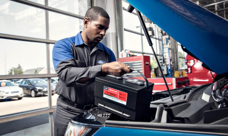 Ford technician replacing a battery