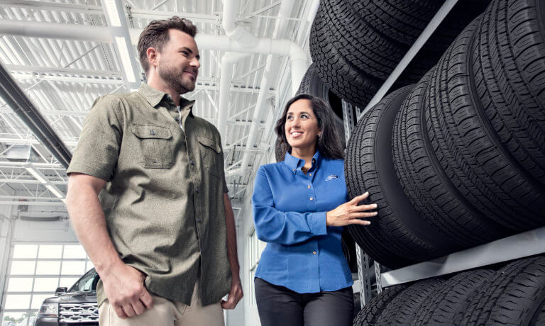 Ford technician showing tires to a customer