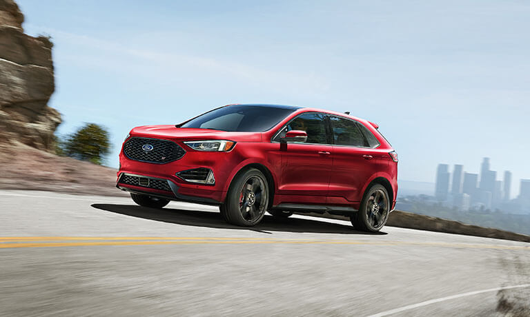 2022 Ford Edge driving away from a city