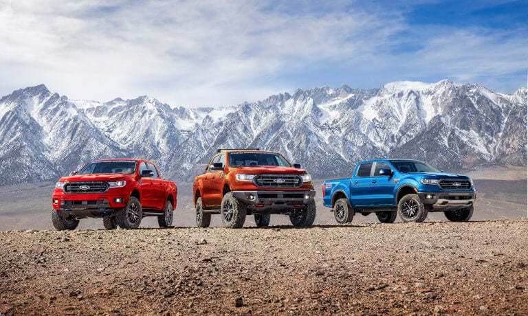Three 2023 Ford Rangers parked side by side in mountains