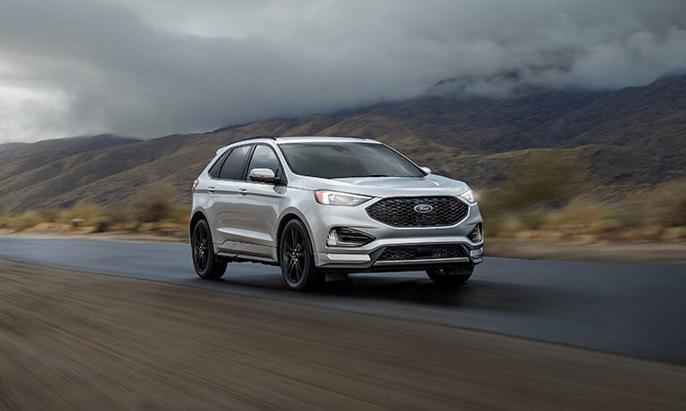 2024 Ford Edge driving under stormy skies