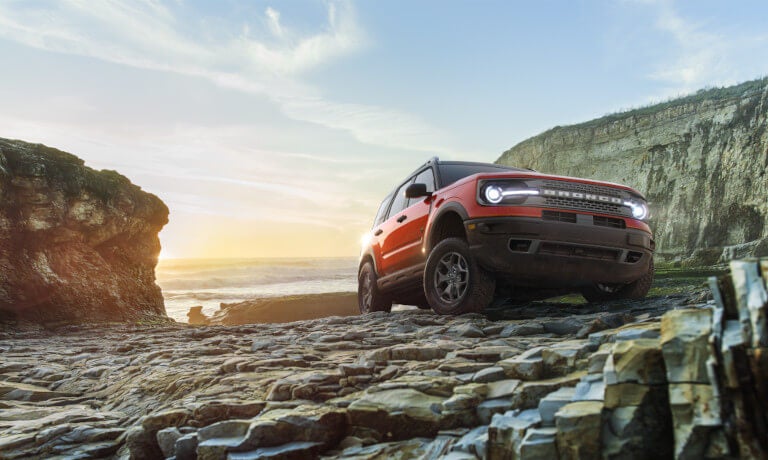 2025 Ford Bronco driving on rocky shore