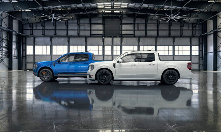 Two 2025 Ford Maverick trucks parked in a warehouse
