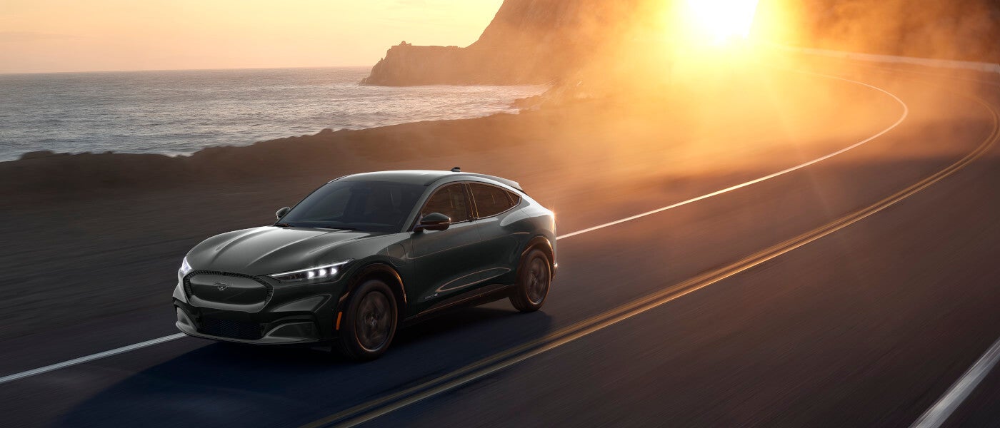 2025 Ford Mustang Mach-E driving away from sunset