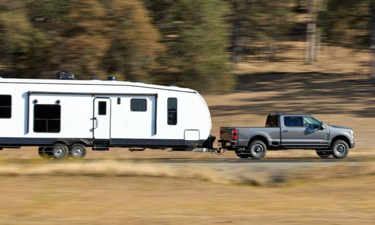 2025 Ford Super Duty side view pulling an RV