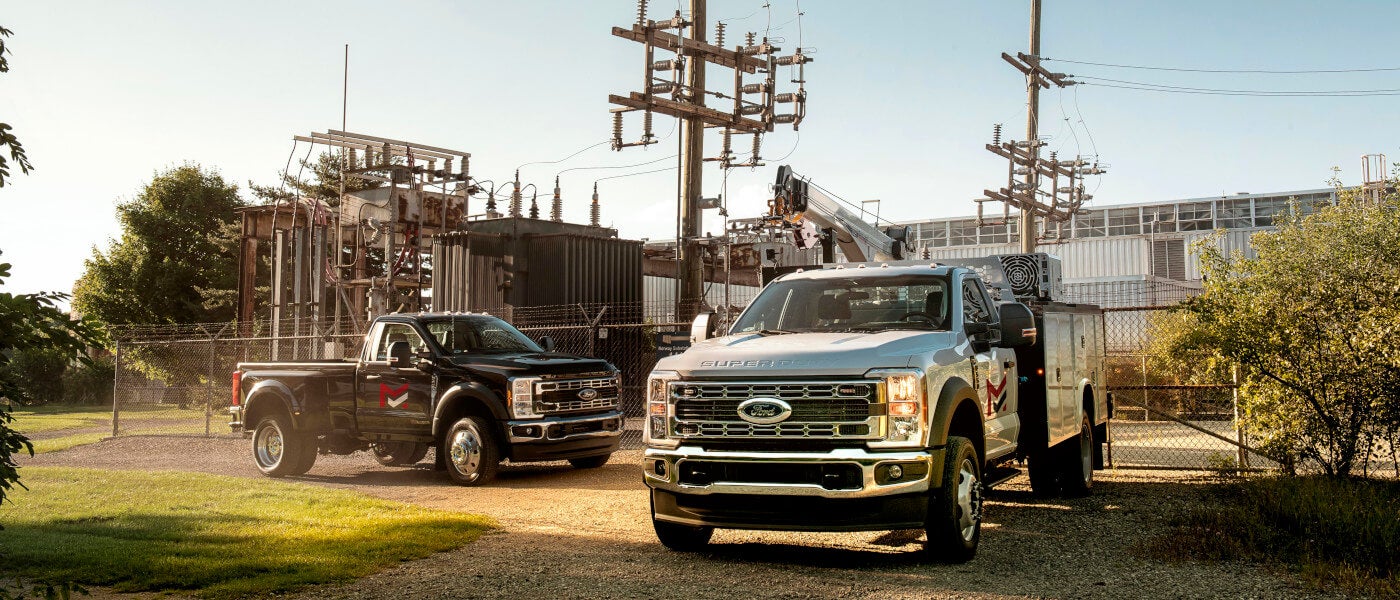 2025 Ford Super Duty pair parked by power plant