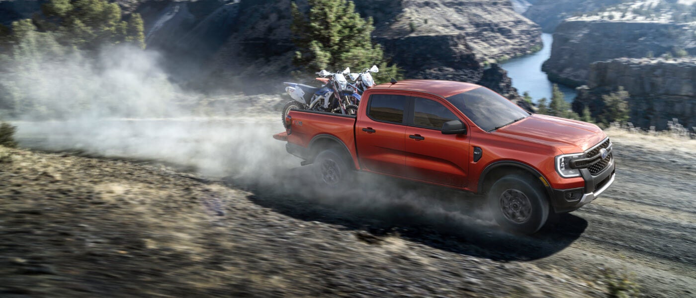 2026 Ford Ranger driving in dust with bikes