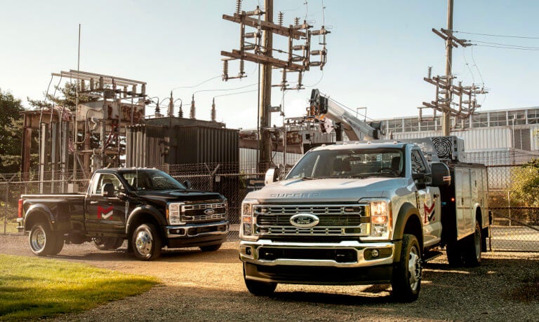 2026 Ford Super Duty pair parked outside power plant