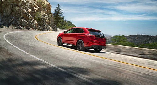 2019 Ford Edge driving by mountains