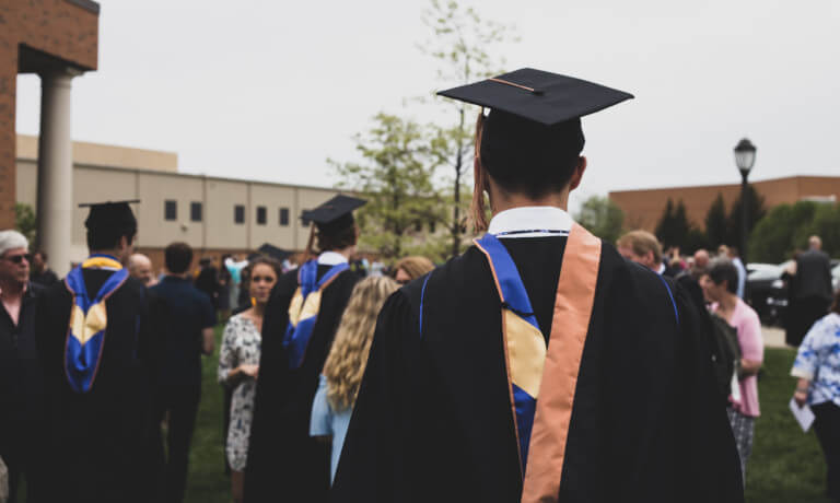 College graduates milling about a courtyard