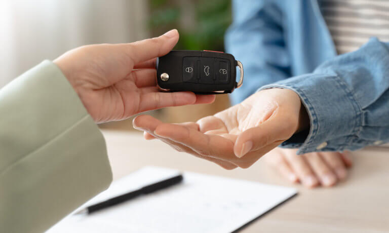 Salesperson handing over car keys