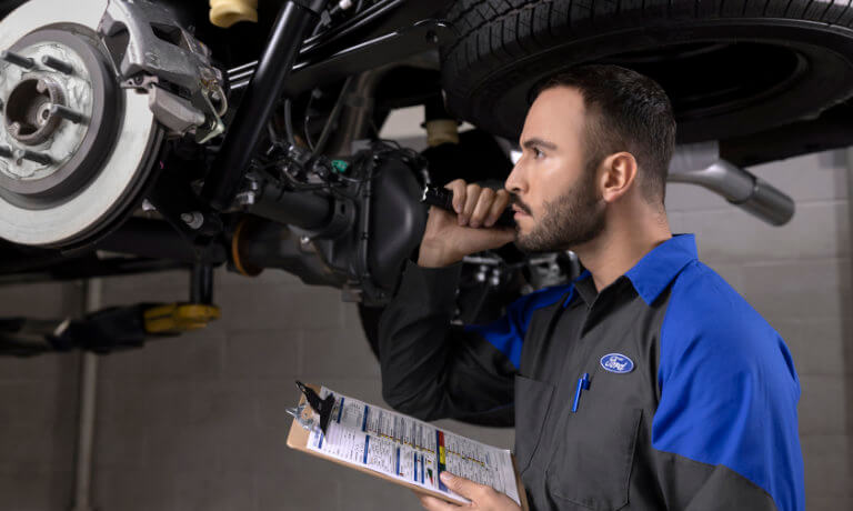 Ford technician inspecting vehicle
