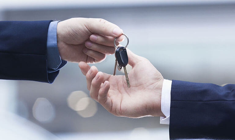 Salesperson handing over car keys