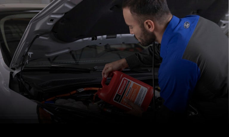 Ford technician pouring oil