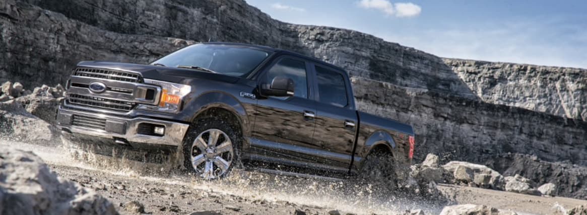 A Ford F-150 driving through a quarry