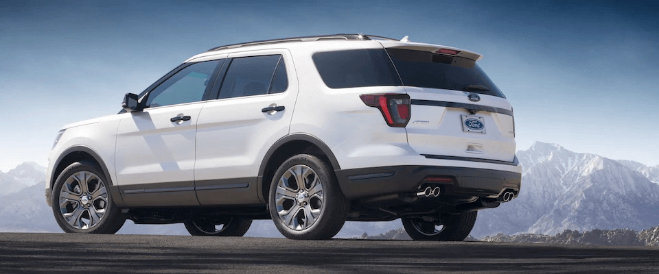 A white 2019 Ford Explorer parked in front of mountains