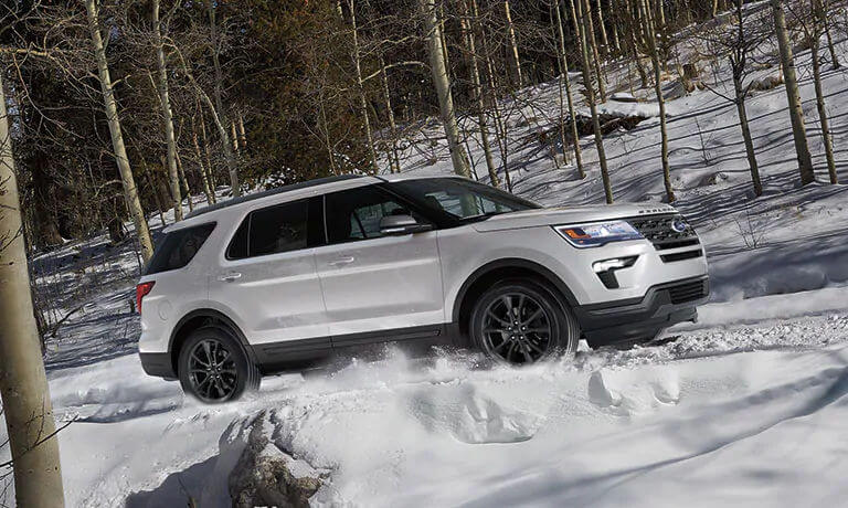 White 2019 Ford Explorer driving through snow